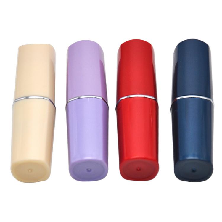Lipstick-shaped pillbox set in beige, purple, red, and navy with caps on.