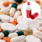 Red lipstick-shaped pillbox with open cap displayed among assorted pills.