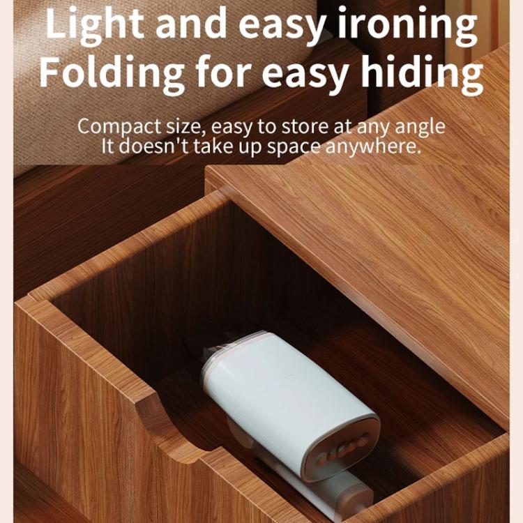 Light blue handheld garment steamer tucked into a wooden drawer