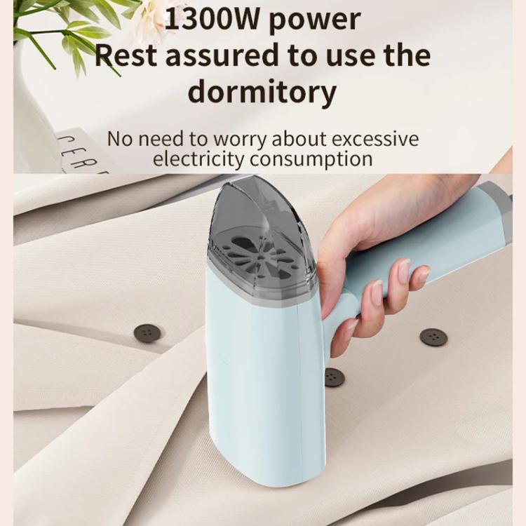 Light blue handheld garment steamer in use with fabric and steam head