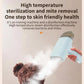 Light blue handheld steamer producing visible steam from the nozzle