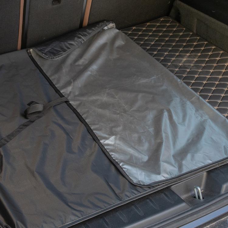 Gray waterproof folding trunk mat with black border and corner straps