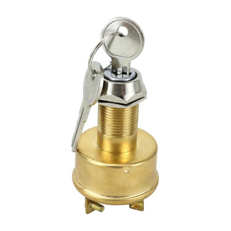 Automotive ignition switch with brass cap, key ring, and visible lock cylinder
