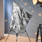 Silver telescope cover with tripod legs shown in front view