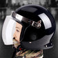Black glossy safety helmet with full face visor and side vent openings