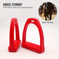 Red plastic horse stirrup pair with ribbed footplates and arched hand grips