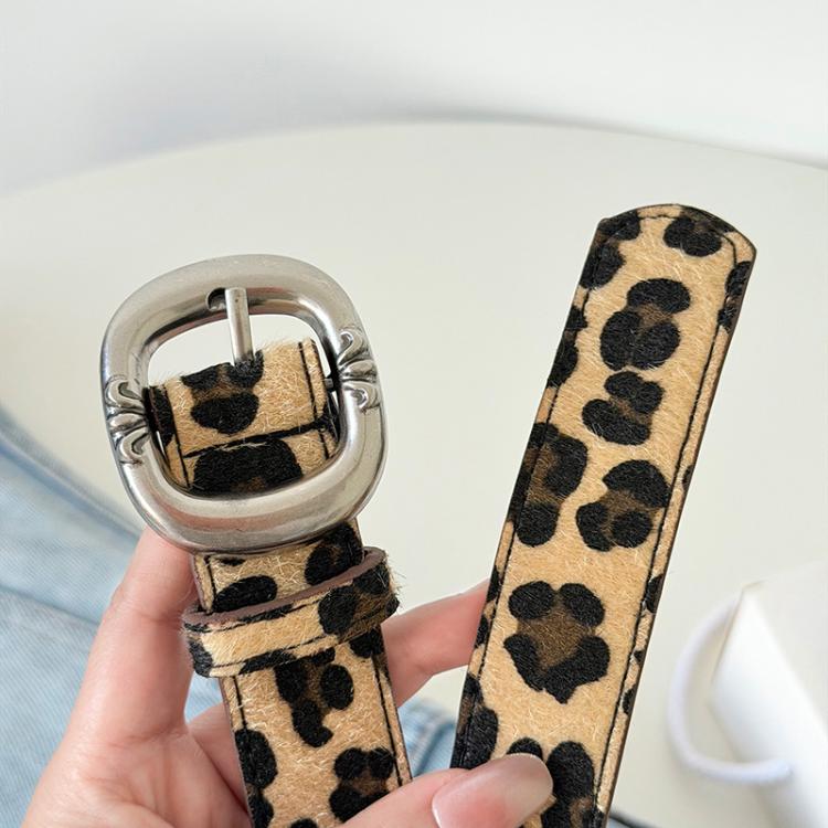 Leopard print belt strap with silver buckle hardware, top view detail