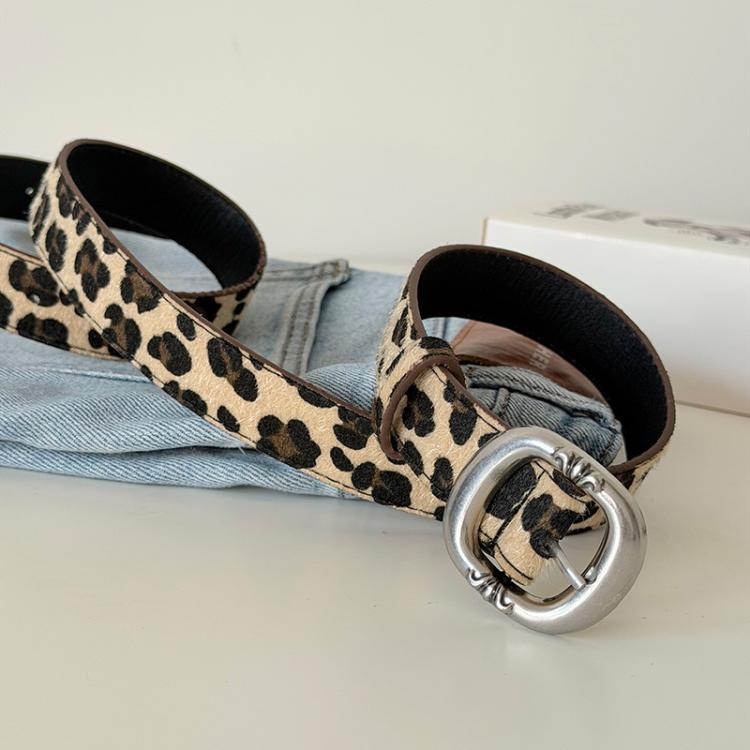 Leopard print belt worn with light denim, silver buckle fastening