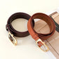 Two leather jeans belts with gold buckles in dark brown and rust tones