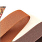 Woven belt straps in rust-brown and dark brown with triangle buckle detail