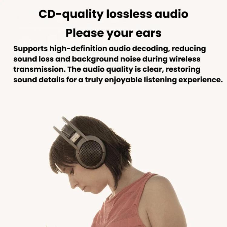 Bluetooth audio adapter next to a person wearing headphones for wireless listening