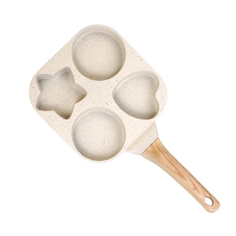 Beige four-hole nonstick frying pan with wooden handle and four egg/burger cups