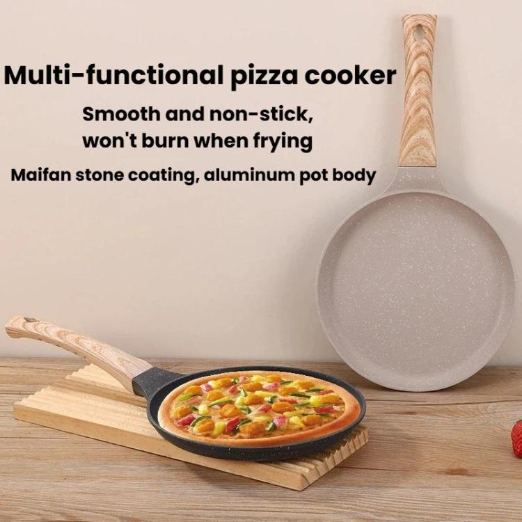 Beige non-stick pizza pan with wooden handle beside topped pizza on boards.
