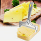 Adjustable thickness cheese slicer with gray-silver frame cutting pale cheese slices