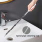 Spiral pipe cleaning rod with white handle and coiled bristles over sink