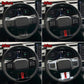 Steering wheel adjustment button area with red accent stripe on trim cover