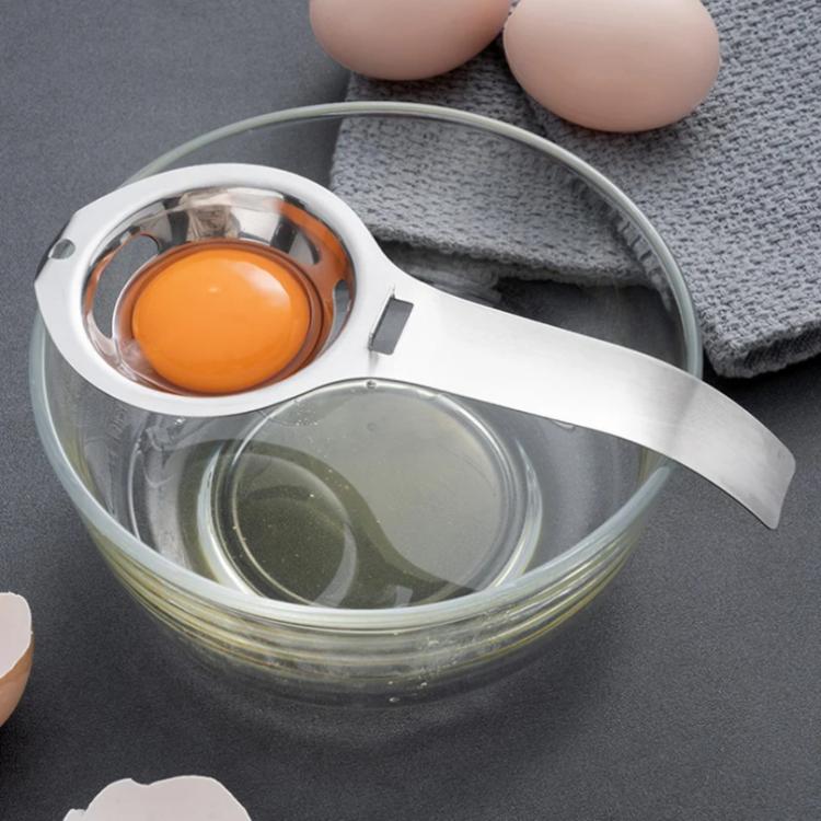 Stainless steel egg yolk separator over bowl, with round strainer cup and handle