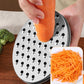 Carrot grating on stainless steel disc with storage cup of shredded carrot