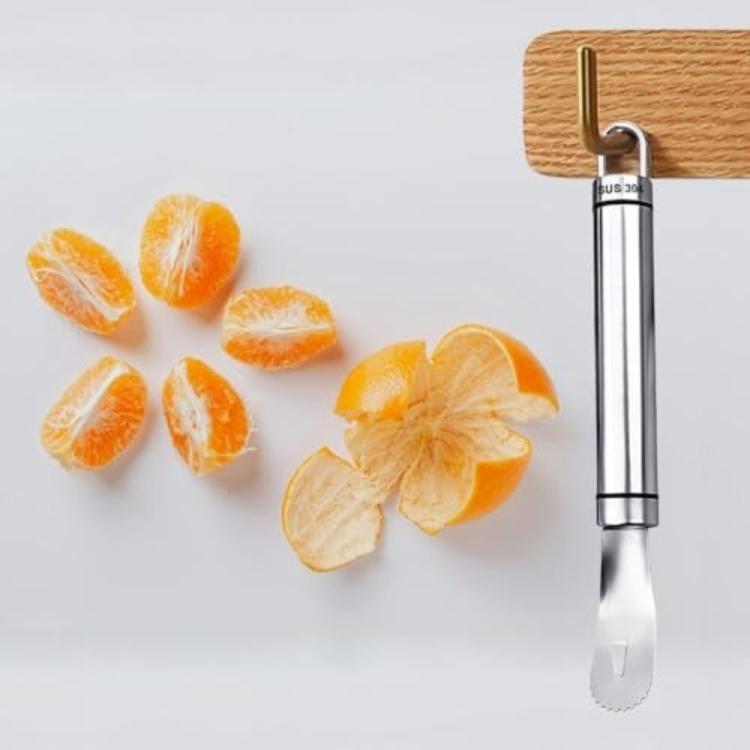 Stainless steel orange peeler with loop handle beside sliced orange pieces
