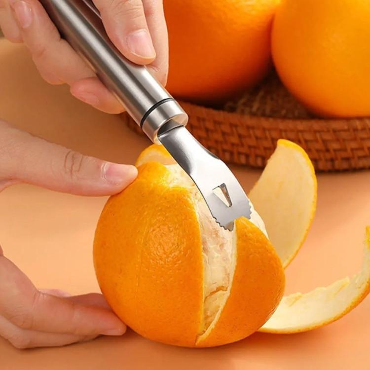 Hands using a stainless steel orange peeler to trim an orange peel