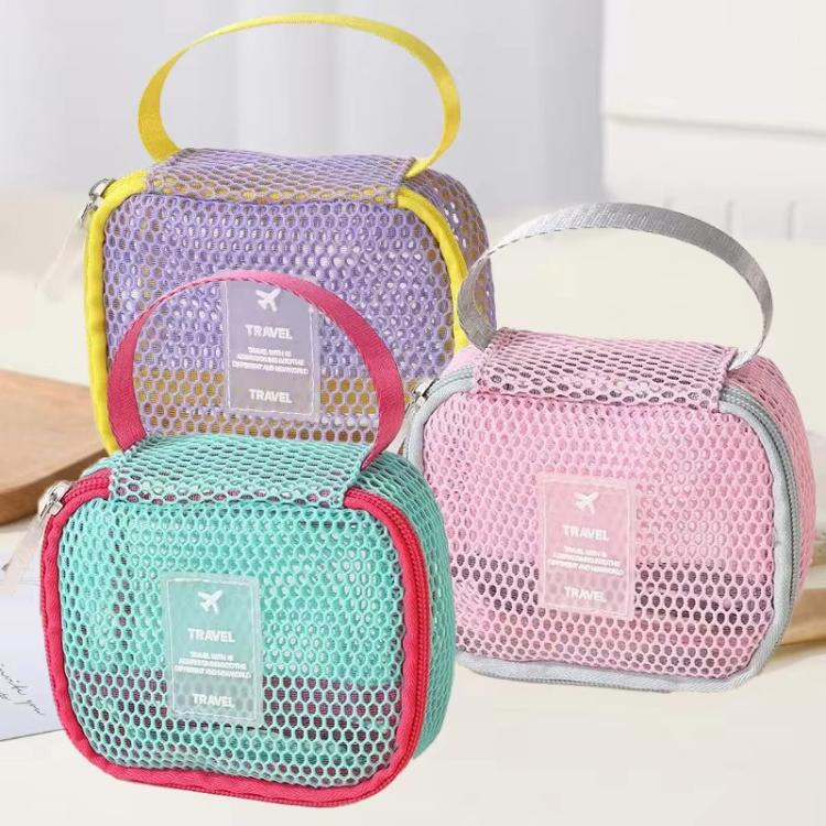 Assorted mesh cosmetic bags in pink and teal with travel label patches and handles