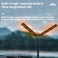 Portable folding LED camping lamp with three illuminated blades extended on tall stand