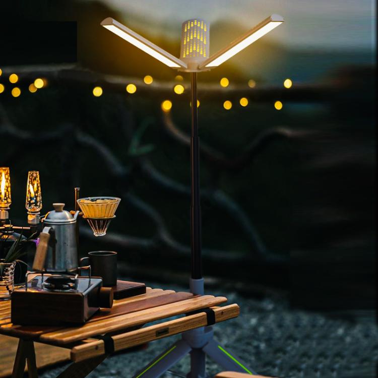 Portable folding LED camping lamp with three illuminated blades extended on tripod base