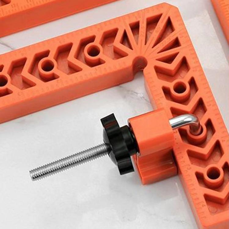 Orange right-angle clamp jig with black knob and threaded steel rods
