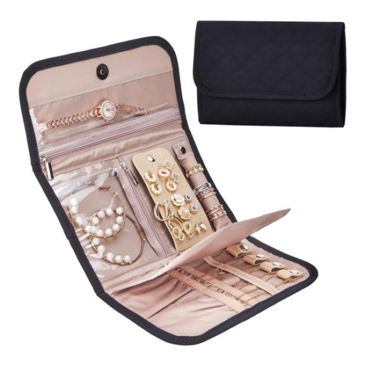 Black faux-suede jewelry storage roll bag with snap flap, open compartments for earrings