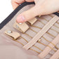Pink faux-suede jewelry roll bag interior with elastic slots, hand adjusting dividers