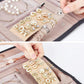 Pink faux-suede jewelry roll bag interior with ring and earring organizers, hands arranging