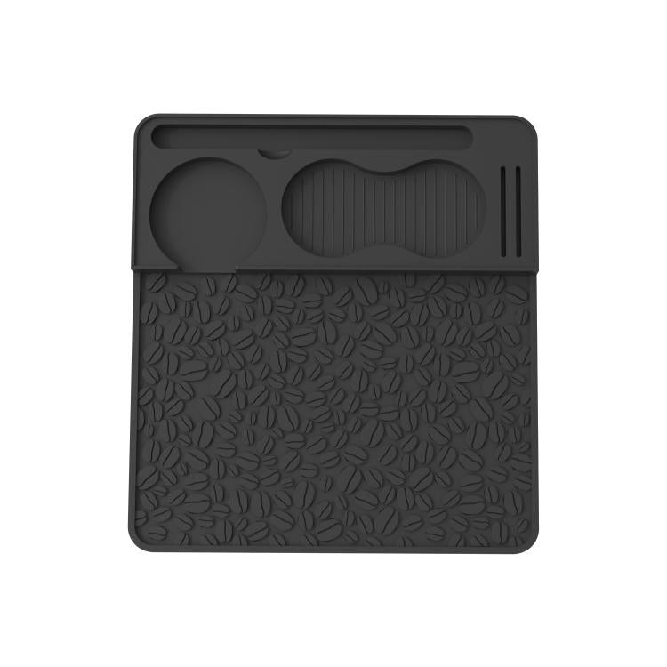 Black silicone espresso tamper mat with leaf-pattern texture and molded holder grooves