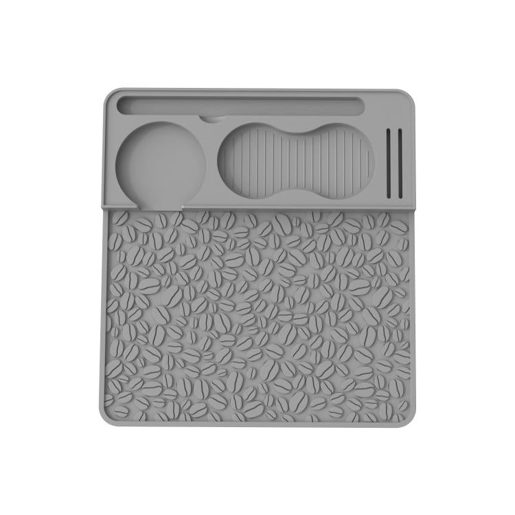 Gray silicone espresso tamper mat with leaf-pattern texture and molded tamper holder