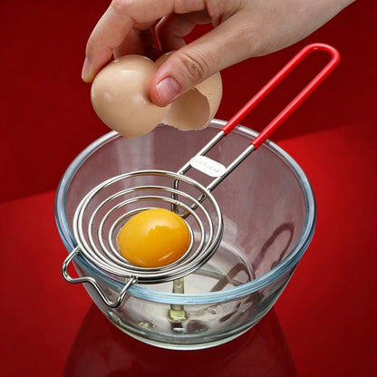 Stainless steel spiral egg separator with red handle, separating egg white in bowl