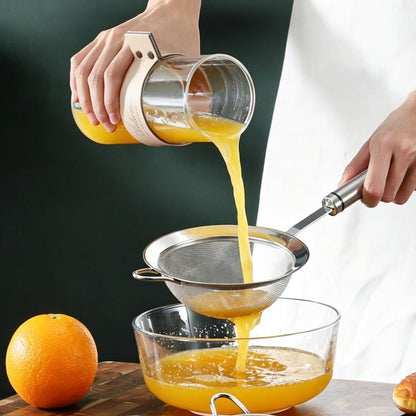 Stainless steel mesh strainer spoon draining liquid over a bowl, with long handle