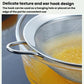 Stainless steel mesh strainer spoon with ear hook, resting on pot rim