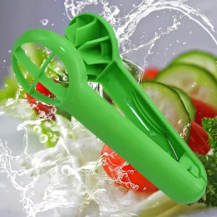 Green fruit slicer with water splash, blade and prongs visible