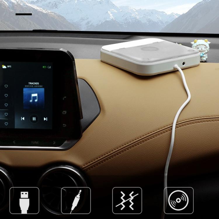 White external CD player connected to car dashboard with USB cable