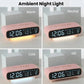 Pink digital alarm clock showing time with ambient night light glow