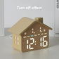 Yellow house-shaped digital alarm clock with illuminated time digits and day-of-week icons