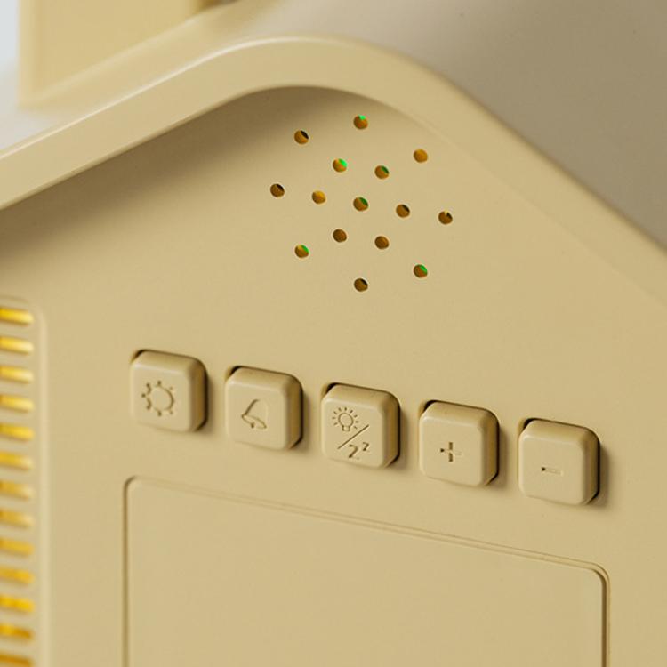 Yellow house-shaped digital alarm clock control panel with buttons and small status icons