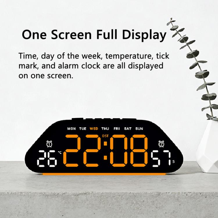 Black digital alarm clock with large orange LED time, weekday, temperature, and DST