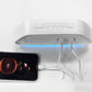 Digital alarm clock with white case, blue LED panel and connected power cables