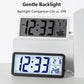 White LCD digital clock with backlight on, showing time and temperature