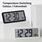 Black LCD digital clock displaying time with temperature readout