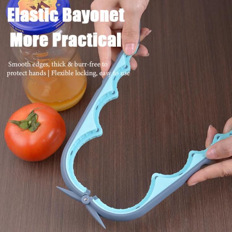 4-in-1 can and bottle cap opener with curved cutting head, held above a tomato