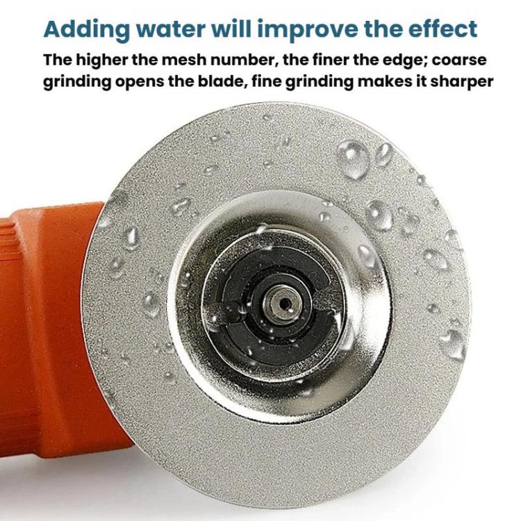 Emery grinding disc with center hole and water droplets on silver-gray abrasive surface