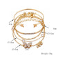 Gold butterfly crystal bracelet set with open cuff and dangling bow and crystal links