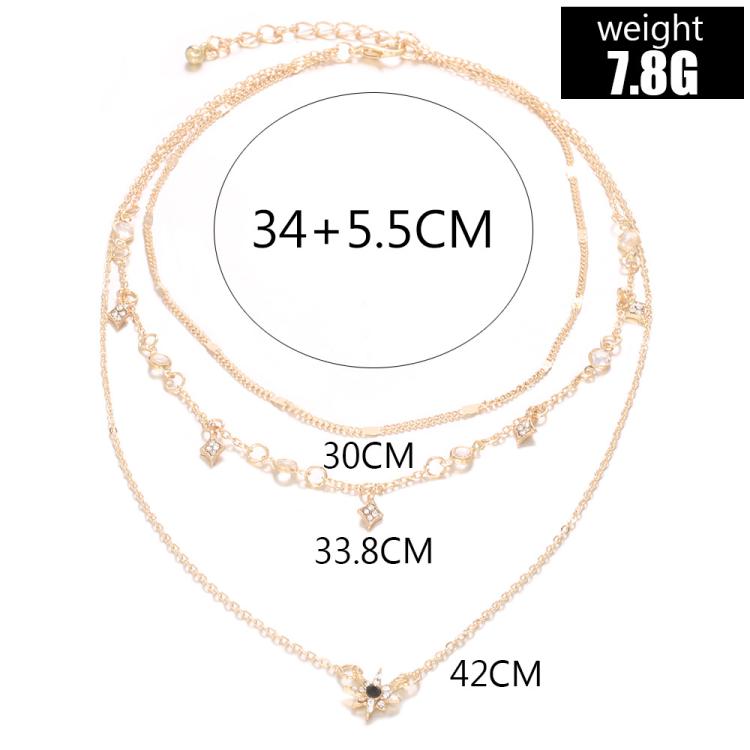 Gold-tone layered star pendant necklace with multiple length measures