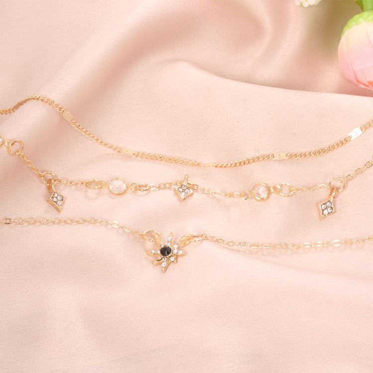 Gold-tone layered star pendant necklace with small clear star charms
